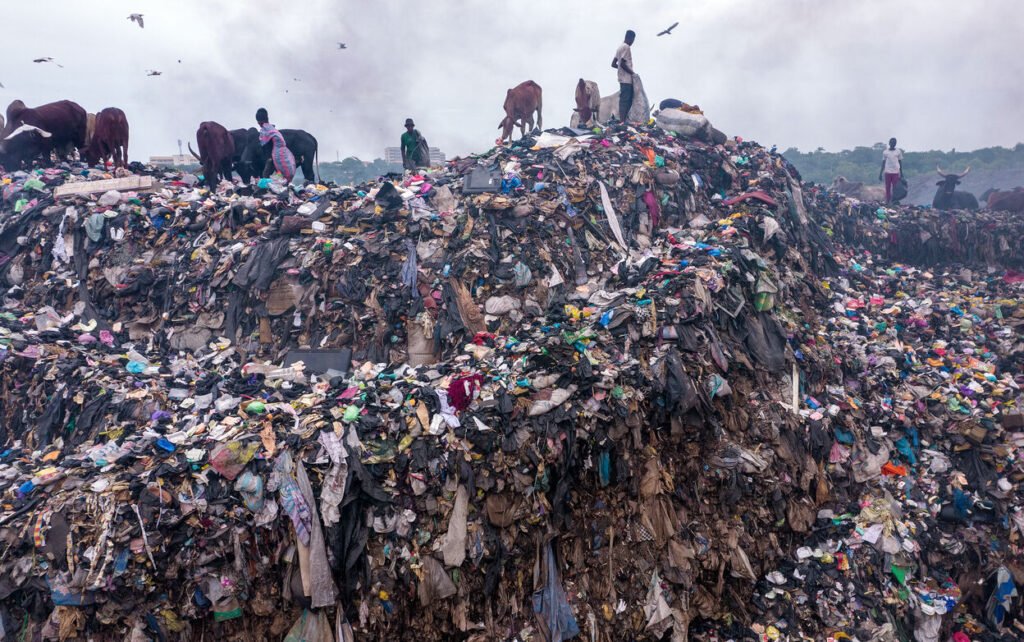 A massive landfill in Ghana filled with discarded clothing, highlighting the environmental impact of fast fashion. Photo by Muntaka Chasant.