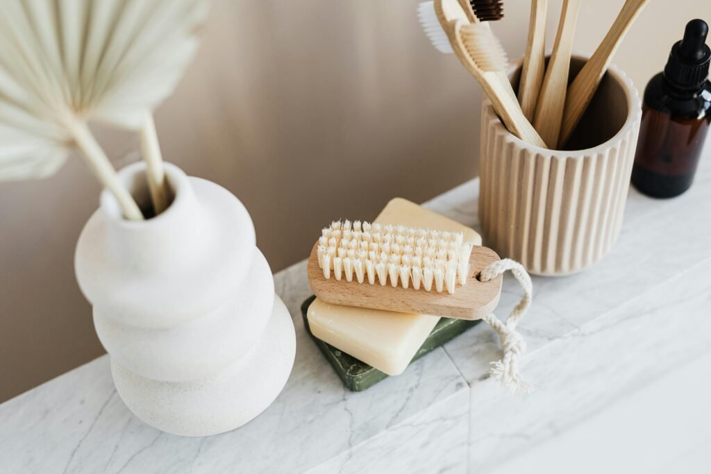 Sustainable bathroom items including bamboo brush and natural soap bars