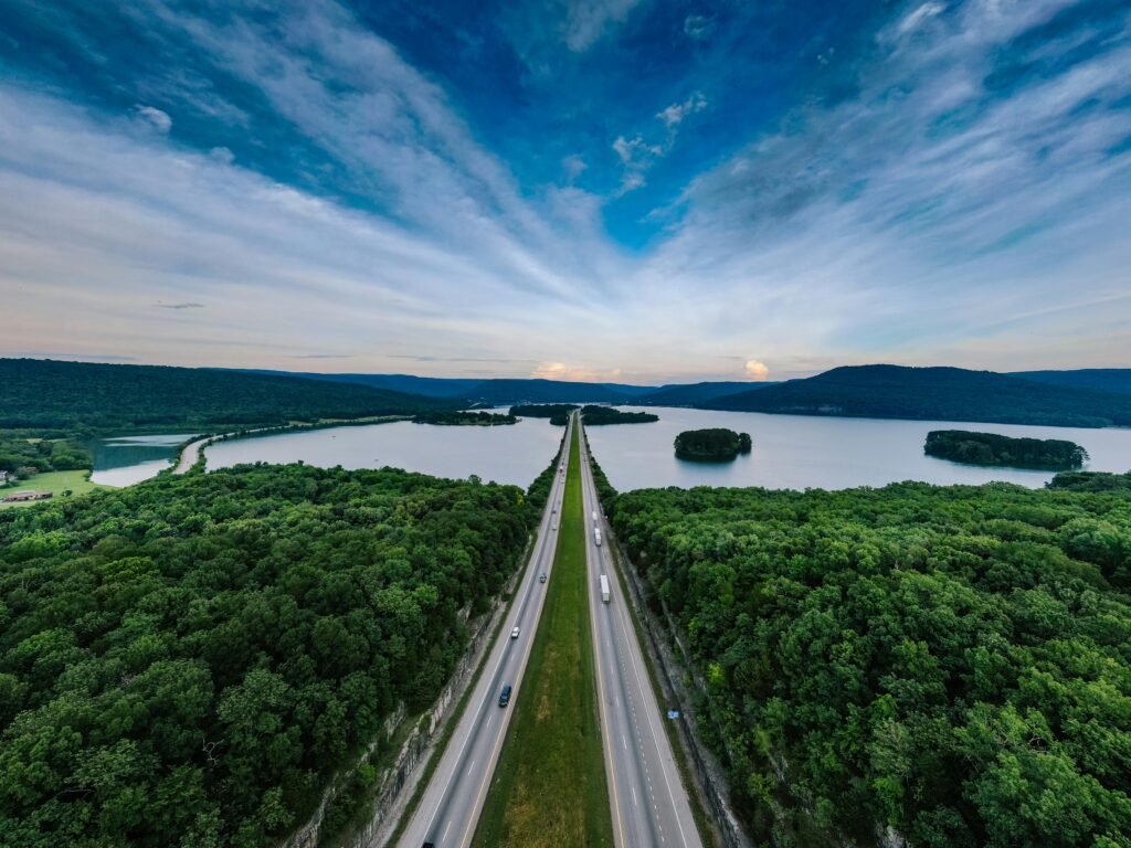 highway that crosses a forest and lake