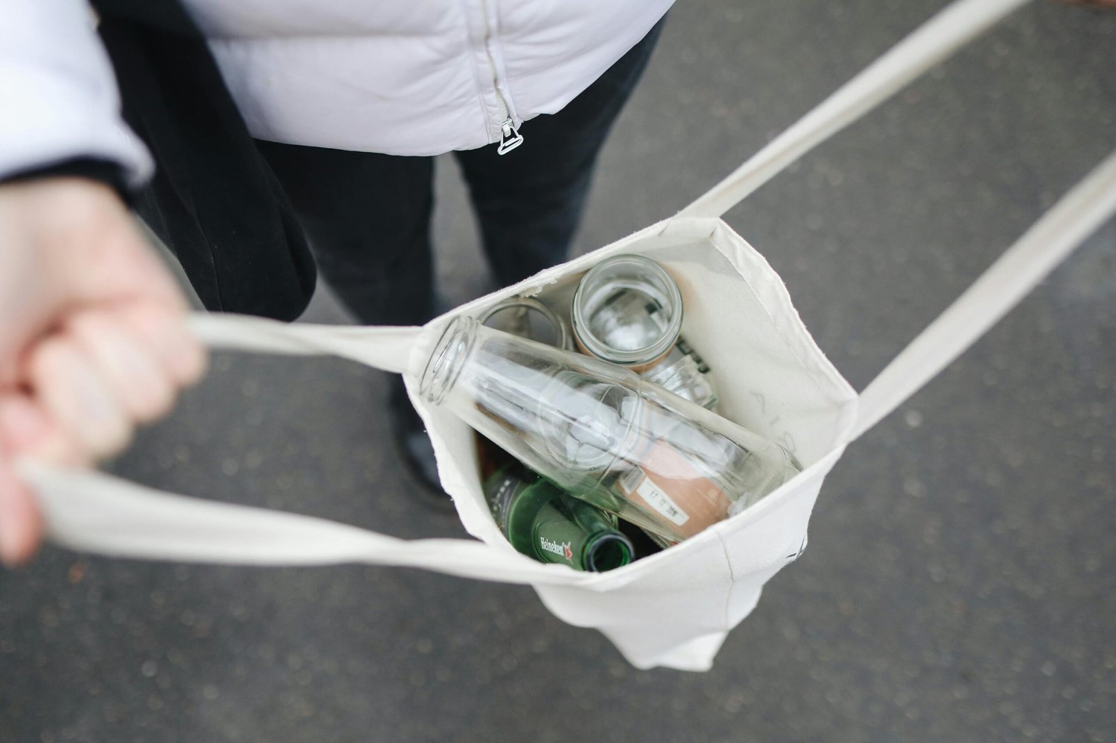 reusable bag full of glass jars and bottles