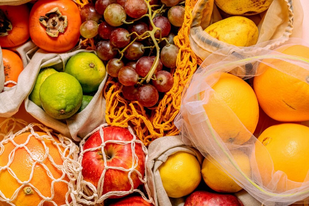 Fresh fruits in reusable mesh produce bags instead of plastic bags