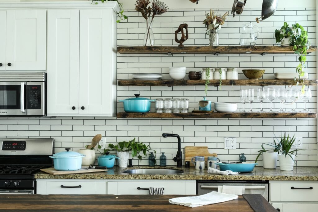 A clean, organized kitchen with reusable containers, plants, and eco-friendly tools.