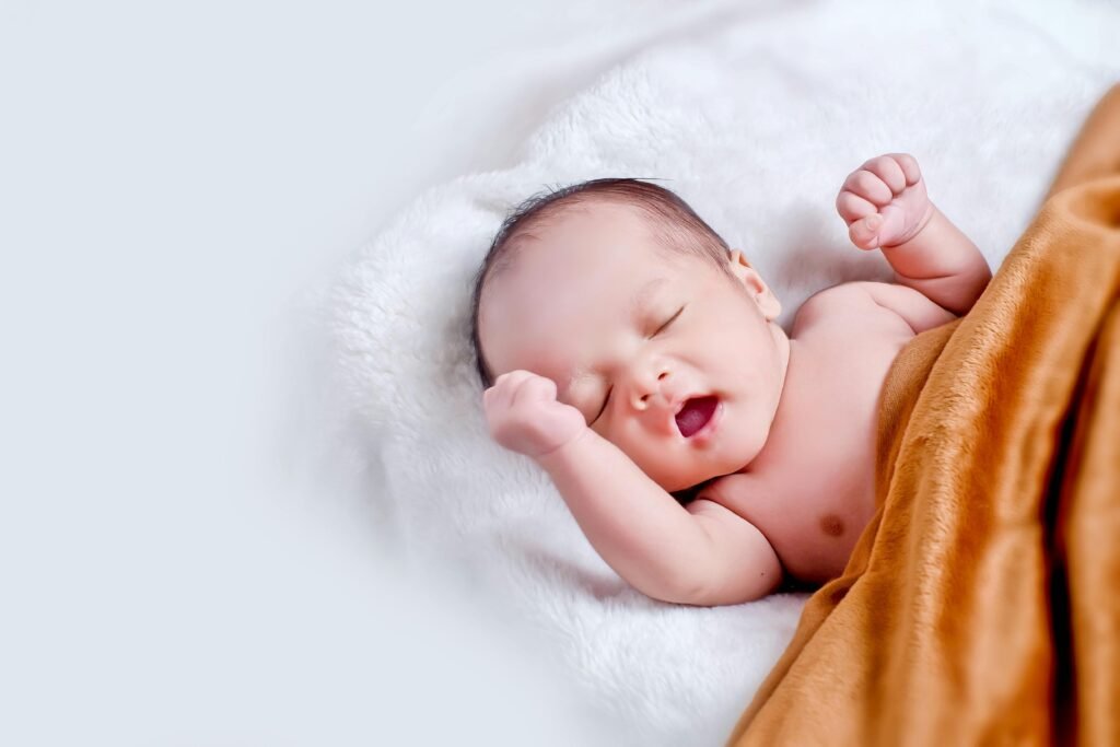 Newborn baby sleeping peacefully on soft, organic cotton and bamboo blankets, representing sustainable baby care practices